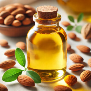 A glass bottle filled with golden almond oil, surrounded by whole almonds, almond shells, and a few green almond leaves. The softly blurred background emphasizes the fresh, organic look of the scene.